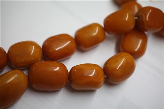 A large single strand graduated amber bead necklace, 36in.